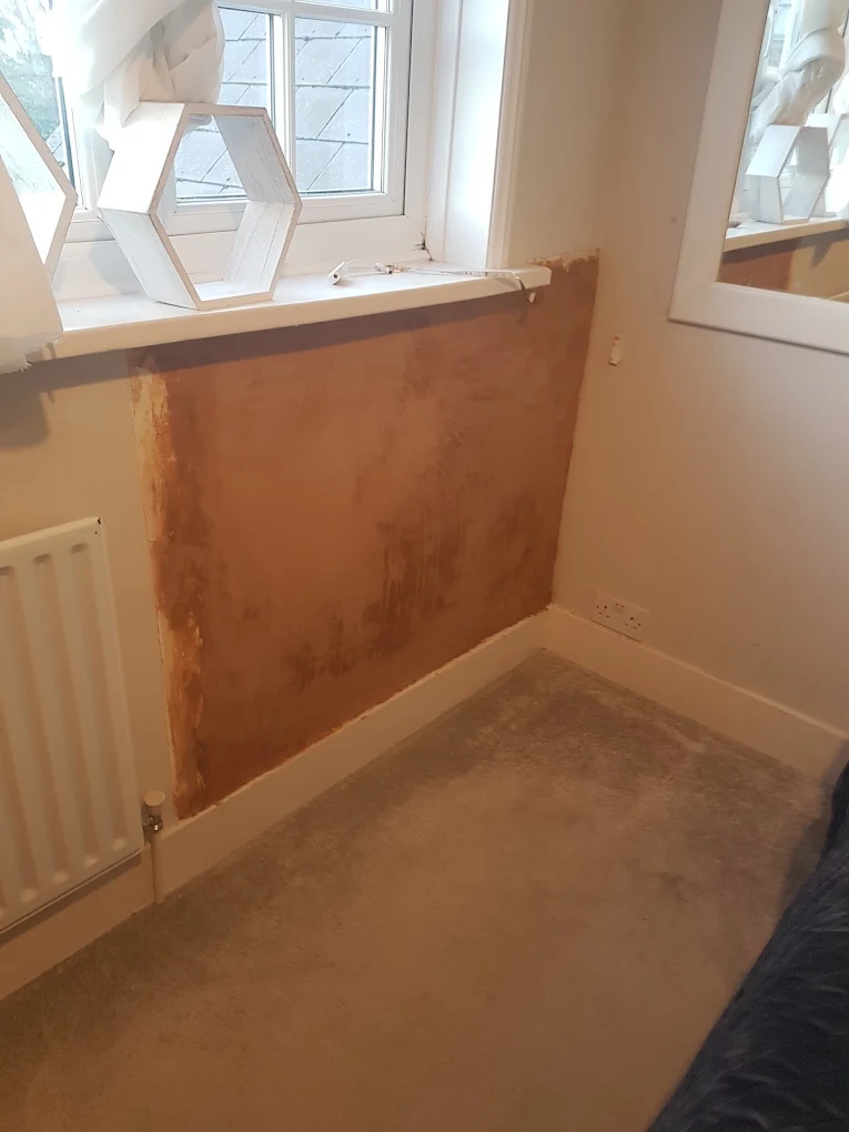 Freshly plastered patch above the radiator beneath the windowsill