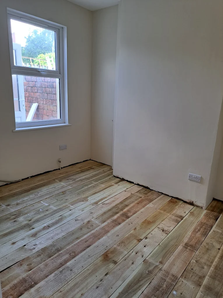 Finished room with new floorboards laid and walls decorated